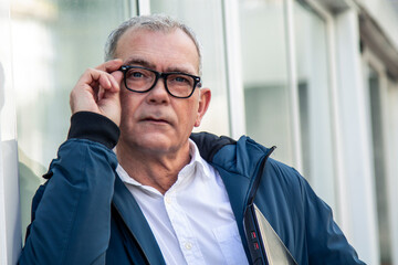 mature man with glasses and laptop