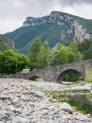 Fototapeta na wymiar Medieval bridge over the river Esca in Burgui/Burgi, Navarre, Spain