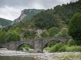 Fototapeta na wymiar Medieval bridge over the river Esca in Burgui/Burgi, Navarre, Spain