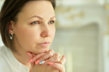 Portrait of a sad young woman posing at home