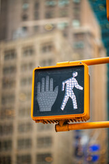 Pedestrian white light on a traffic light in New York City, lett