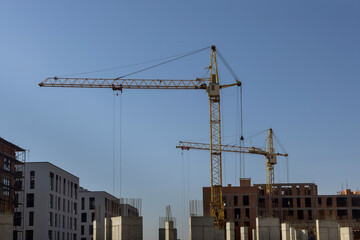 Aerial view with high rise building under construction at tower cranes