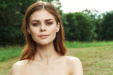 beautiful woman in a field outdoors bare shoulders clear skin cropped view