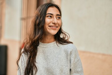 Young middle east girl smiling happy standing at the city.