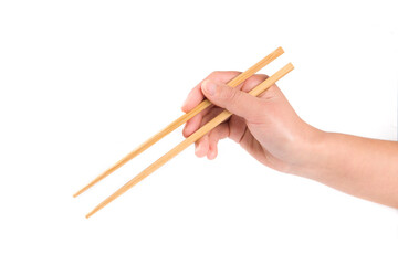 Person 's right hand using bamboo chopsticks against white background