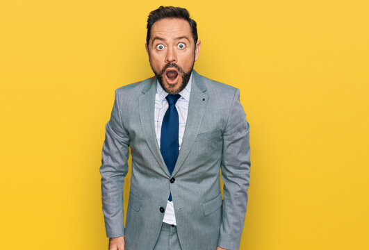 Middle age man wearing business clothes afraid and shocked with surprise and amazed expression, fear and excited face.