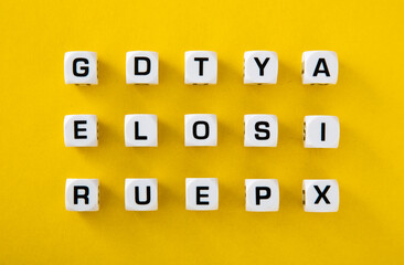 White cubes with letters scattered randomly