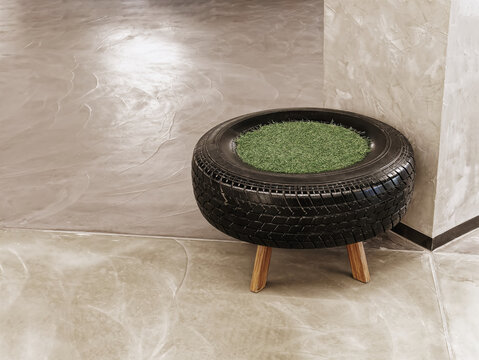 Reuse Chair Concept made of Old Rubber Tire and Green Grass