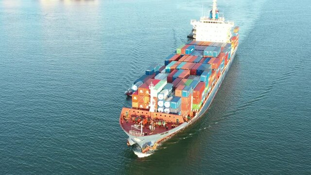 CHONBURI,THAILAND - MAY 23, 2021:The KMTC BANGKOK cargo container ship  ploughs through waters at sea,Aerial view is leaving the port to send goods abroad,Logistics and Supply Chain