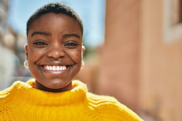 Young african american woman smiling happy standing at the city.