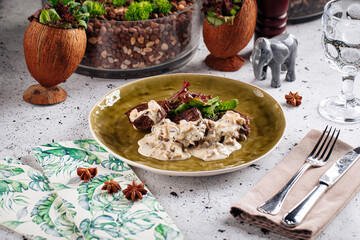 Gourmet veal medallions with sauce on decorated background