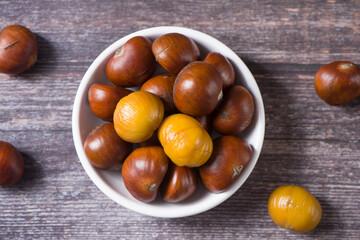 Fototapeta premium Close-up Chestnuts with peeled isolated on white background.
