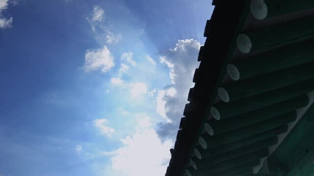 Clouds flowing over the eaves of traditional Korean hanok architecture