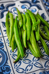 Green beans on blue and white background. Top view. Close up.