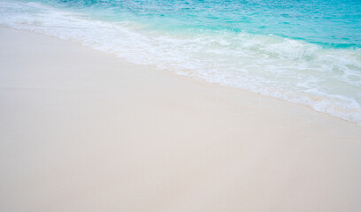 Beach with white sand and soft blue ocean wave