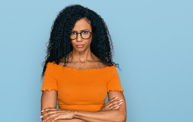 Middle age african american woman wearing casual clothes and glasses skeptic and nervous,...