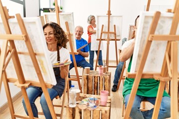 Obraz premium Group of middle age draw students smiling happy drawing at art studio.