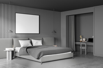 Corner of grey bedroom with niche desk and horizontal canvas