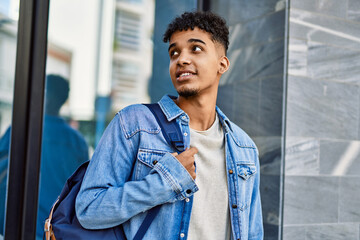 Hispanic young man smiling at the university