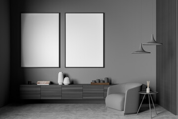 Grey armchair in dark living room interior with coffee table, mockup posters