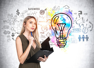 Businesswoman with clipboard, colourful lightbulb sketch doodle on concrete wall