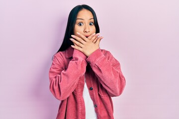 Obraz premium Beautiful hispanic woman with nose piercing wearing casual pink jacket shocked covering mouth with hands for mistake. secret concept.