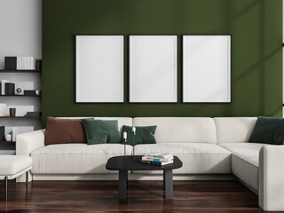 Three canvases on green wall in living room