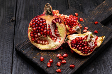 Ripe pomegranate on a dark wooden background