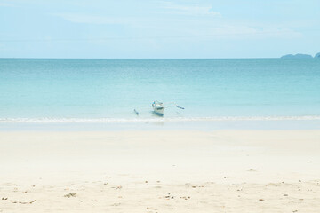 Traditional Outrigger canoe on a beach. Minimal pastel colours.