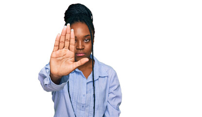 Young african american woman wearing casual clothes doing stop sing with palm of the hand. warning expression with negative and serious gesture on the face.