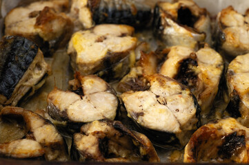 fresh chopped mackerel baked in the oven in pieces, close-up