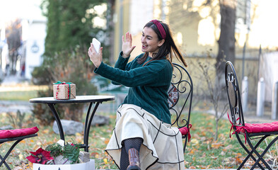 Stylish young woman on a walk after shopping, Christmas preparations.