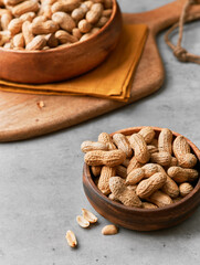 Image of bunch of peanuts in a bowl on a concrete surface