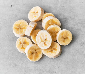 Photo of banana slices on a concrete surface