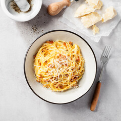 Dish of Spaghetti alla Carbonara, classic italian recipe of pasta with guanciale, egg yolk and parmesan cheese. Top view. 