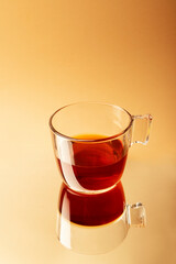 transparent tea cup on mirror with reflection