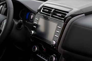 Obraz na płótnie Canvas The interior of the car. Car-mounted tablet with mockup