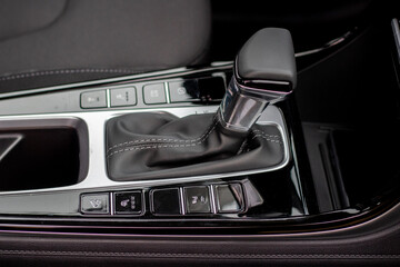 Fototapeta na wymiar The interior of a new car. Automatic transmission in leather trim