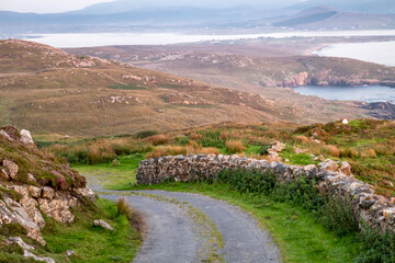 The coastal single track road between Meenacross and Crohy Head south of Dungloe, County Donegal -...