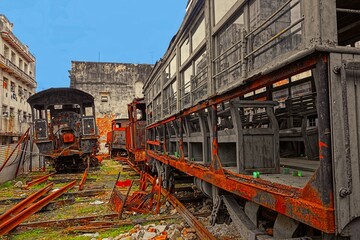 Rusty and old steam locomotives and freight cars abandoned in a yard in central Havana, Cuba.