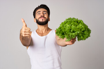 bearded man in white t-shirt lettuce leaf vegetables healthy food