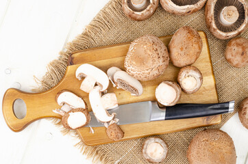 Fototapeta na wymiar Fresh brown cultivated mushrooms champignons on wooden background. Studio Photo