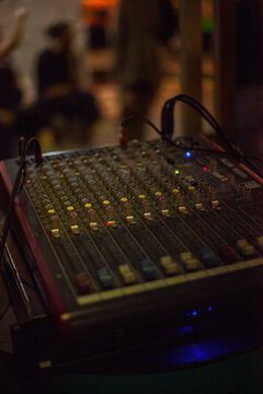 Vertical photo of a sound console at a disco. Music concept