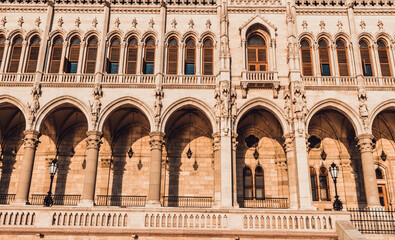 Fototapeta na wymiar Hungarian Parliament building in Budapest at the daylight. Gothic architecture exterior. Tourist destination. Beautiful columns architecture details at the sunlight