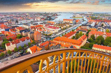 Fototapeta na wymiar Skyline of Copenhagen from external winding staircase to the top of church of Vor Frelsers Kirke during sunset, Copenhagen, Denmark