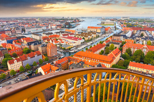 Skyline of Copenhagen from external winding staircase to the top of church of Vor Frelsers Kirke during sunset, Copenhagen, Denmark