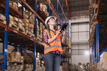 Fototapeta na wymiar Logistic concept,Female staff checking stock inventory at warehouse or distribution center