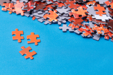 Mixed Peaces of a Colorful Jigsaw Puzzle Lie on the Blue Background - Strategy and Solving Problem Concept