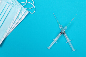 Vaccination, Immunology or Revaccination Concept - Two Medical Syringe Lying on Blue Table in Doctor's Office in a Hospital or Clinic