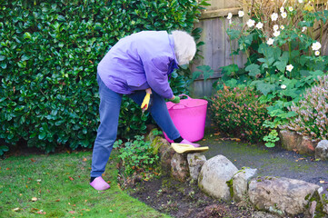 Senior elderly person active lifestyle in garden during summer